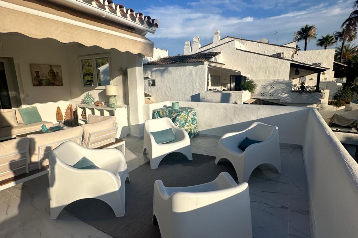 Spacious private terrace of a luxury penthouse in Puerto Banús featuring stylish outdoor seating, modern Mediterranean décor, and a relaxing lounge area just moments from the beach and marina.
