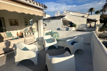 Spacious private terrace of a luxury penthouse in Puerto Banús featuring stylish outdoor seating, modern Mediterranean décor, and a relaxing lounge area just moments from the beach and marina.